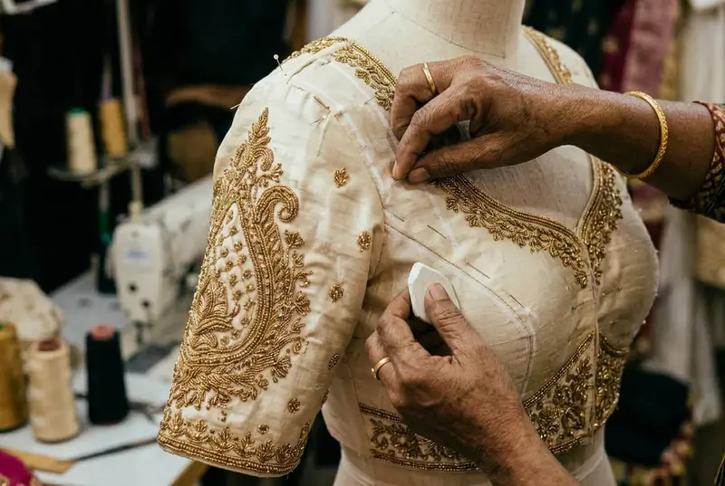 Bridal blouse fitting session with tailor measuring and adjusting