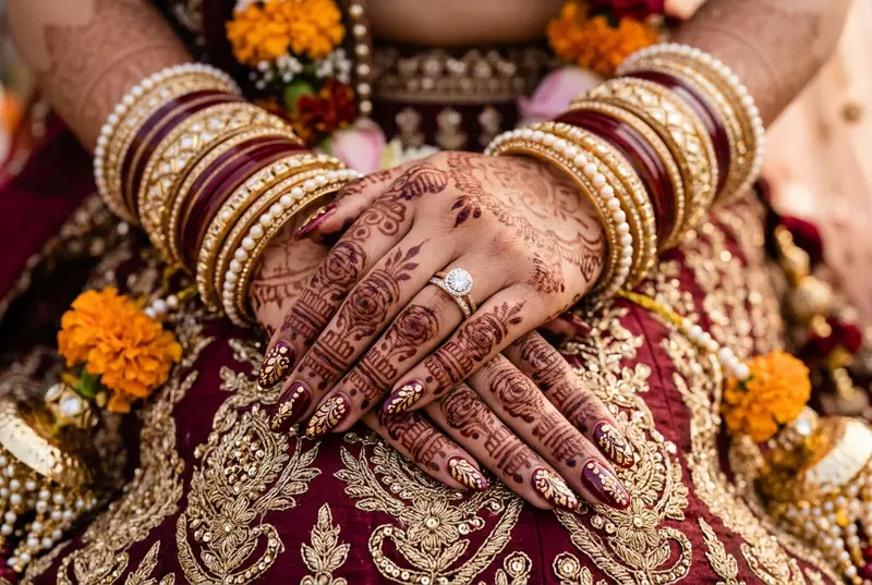 Indian bride's nail art matching her bridal lehenga colour