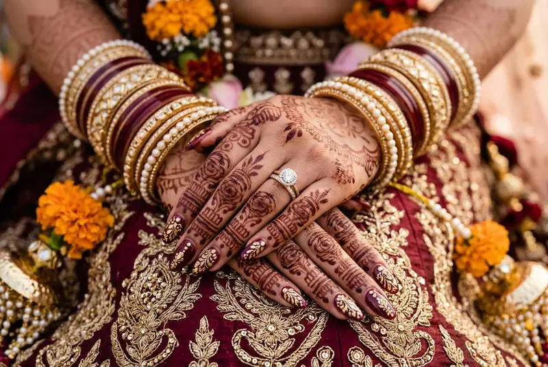 Indian bride's nail art matching her bridal lehenga colour