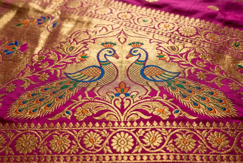 Close-up of Maharashtrian Paithani silk saree with purple and gold peacock border